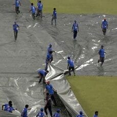Ground staff using super soppers to clear rainwater at Eden Gardens